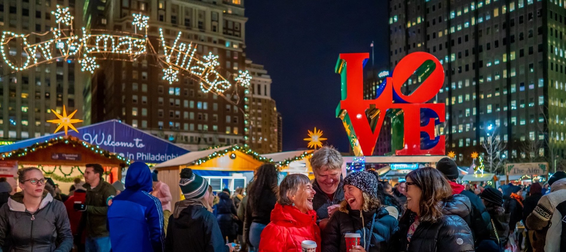 people smiling, skyscrapers, night, lit up signs, lights