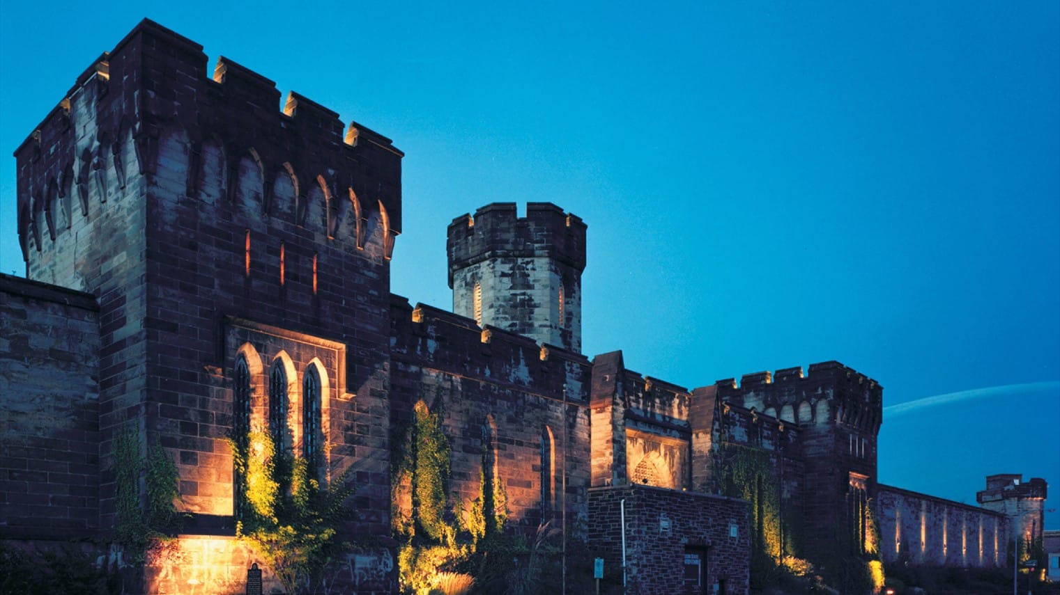 Large old prison building at night time