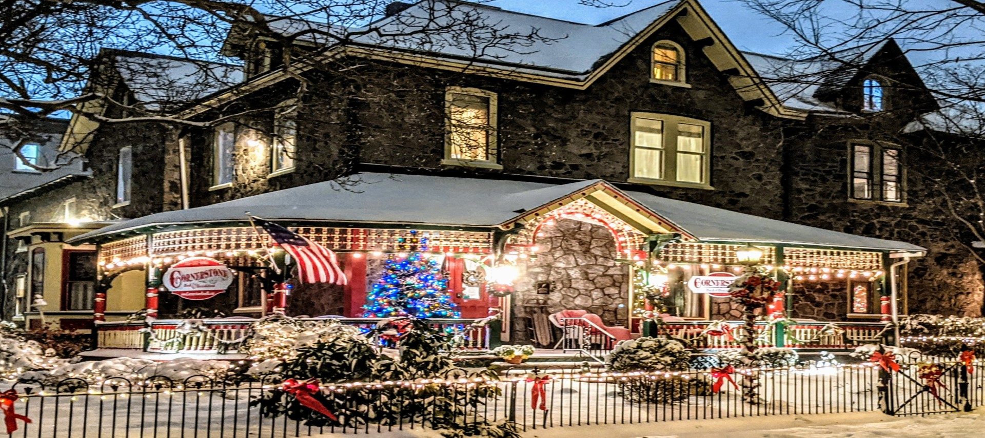 Snow covered house with Christmas lights and decorations